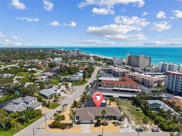 Coastal home boasts charming landscaping and easy access to the beach and nearby city amenities at 714 & 716 Apalachicola Rd, Venice, FL 34285