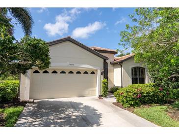 Charming home with a two-car garage, tile roof, and lovely landscaping at 8078 Stirling Falls Cir, Sarasota, FL 34243