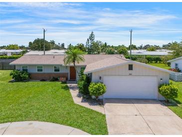 Charming single-story home with a well-maintained lawn, inviting curb appeal, and two car garage at 3621 S Lockwood Ridge Rd, Sarasota, FL 34239