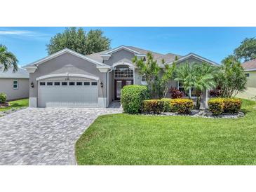 Charming single-story home with well-maintained landscaping and a brick-paved driveway leading to a two-car garage at 5142 51St W Ln, Bradenton, FL 34210