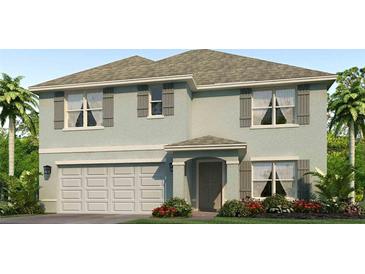 Charming two-story home boasts a gray color scheme, attached two-car garage, and beautifully landscaped front yard at 11203 40Th E Ave, Palmetto, FL 34221