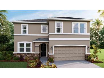 Beautiful two-story home featuring stone accents, neutral colors, and an attached two-car garage at 17904 Tavernside Trl, Bradenton, FL 34211