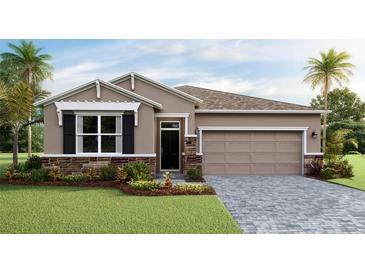 Charming single-story home features a stone veneer, a two-car garage and a well-manicured lawn at 18228 Beach Ranch Ter, Lakewood Ranch, FL 34211