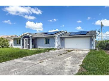 Charming single-story home with a well-maintained lawn, screened-in front porch, and solar panels at 3339 Duar Ter, North Port, FL 34291