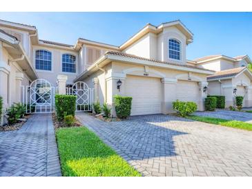 Well maintained townhouse featuring a private gated entrance, paver driveway, and two car garage at 4487 Cinnamon Dr # 2604, Sarasota, FL 34238
