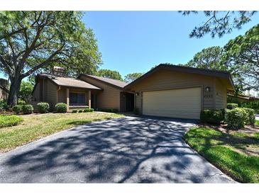 Charming single-story home featuring a two-car garage and a well-maintained lawn with mature landscaping at 4555 Chandlers Forde # 47, Sarasota, FL 34235
