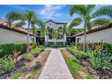 Beautiful condo complex featuring lush landscaping and a welcoming walkway to the units at 5695 Palmer Cir # 203, Bradenton, FL 34211