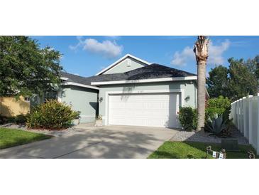 Charming home with a well-manicured lawn, complemented by a lush garden and a spacious two-car garage at 6107 French Creek Ct, Ellenton, FL 34222