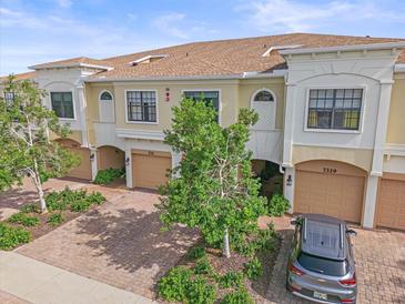 Beautifully maintained townhomes with brick driveways, tan exteriors, and two car garages at 7325 Skybird Rd # 399, Bradenton, FL 34209