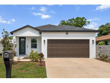Charming single-story home with a well-manicured lawn, features a brown garage door and appealing curb appeal at 4920 69Th N St, St Petersburg, FL 33709