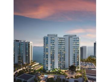 Modern high-rise condos with beautiful waterfront views and manicured landscaping at 555 Quay Commons # 1402, Sarasota, FL 34236