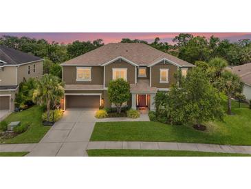 Beautiful two-story home with a well-manicured lawn and mature landscaping at 6306 Anise Dr, Sarasota, FL 34238