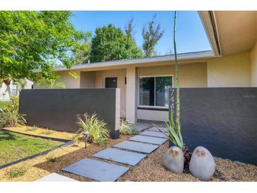 Inviting front yard with stone walkway and modern landscaping enhances the home's curb appeal at 7442 N Leewynn Dr, Sarasota, FL 34240