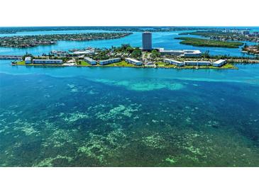 Stunning aerial view of waterfront property with turquoise water and lush landscaping at 767 John Ringling Blvd # 25, Sarasota, FL 34236