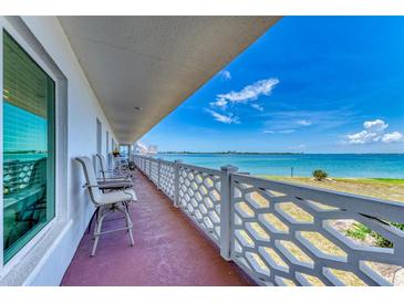 Enjoy beautiful ocean views from this condo balcony with seating and stylish white railings at 767 John Ringling Blvd # 25, Sarasota, FL 34236