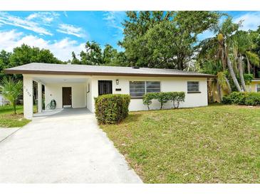Charming single-story home featuring a well-maintained lawn, a convenient carport, and a freshly painted exterior at 1354 22Nd St, Sarasota, FL 34234