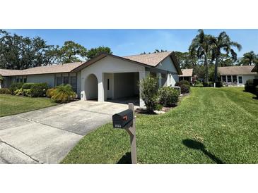 Charming one-story villa with a carport and well-manicured lawn at 1553 Stewart Dr # 513, Sarasota, FL 34232