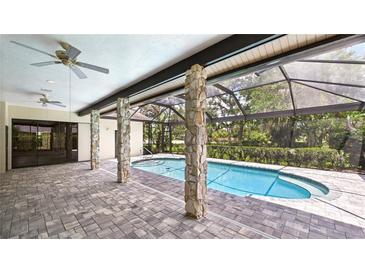 A lovely covered pool is surrounded by beautiful pavers and has direct access to the main house at 6107 Misty Oaks St, Sarasota, FL 34243
