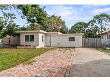 Charming single-story home with a brick driveway and a well-manicured lawn at 8075 48Th N Ave, St Petersburg, FL 33709