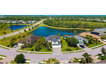 An aerial view of a home in a community with ponds and lush landscaping on an expansive lot at 826 Honeyflower Loop, Bradenton, FL 34212