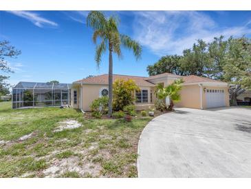 Charming single-story home with lush landscaping and a screened-in pool enclosure at 1026 Graham Rd, Venice, FL 34293