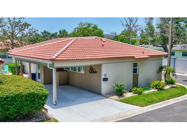 Charming home featuring a red tile roof, well-maintained landscaping, and a convenient covered carport at 139 Vista Hermosa Circle, Sarasota, FL 34242