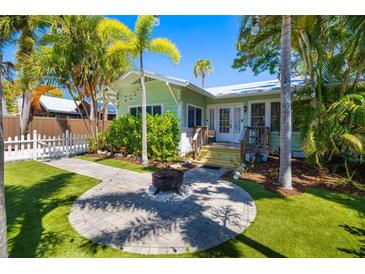 Charming cottage with inviting backyard, fire pit, and lush lawn, perfect for outdoor enjoyment at 1871 Prospect St, Sarasota, FL 34239