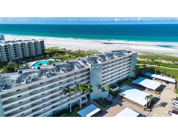 Aerial view of the building with beachfront access at 5750 Midnight Pass Rd # 203, Sarasota, FL 34242