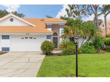Charming single-Gathering home featuring a tile roof, well-manicured lawn, and beautiful landscaping at 6755 Approach Rd # 31, Sarasota, FL 34238