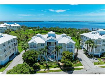 Stunning aerial view of a waterfront condo complex, surrounded by lush greenery and offering beautiful water views at 7820 34Th W Ave # 102, Bradenton, FL 34209
