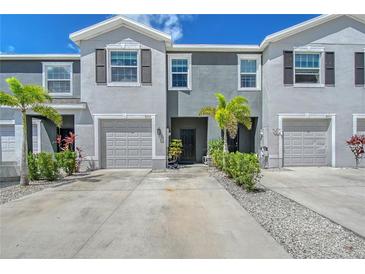Inviting townhome exterior featuring well-maintained landscaping and attached garages at 8557 Milestone Dr, Sarasota, FL 34238
