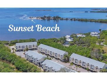 Aerial view of complex with beach access to tranquil waters at 1500 Sunset Rd # B4, Tarpon Springs, FL 34689