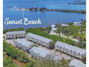 Beautiful aerial view of coastal condo community and sunset beach with blue waters in the background at 1500 Sunset Rd # B4, Tarpon Springs, FL 34689