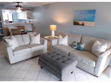 Cozy living room featuring comfortable seating, an ottoman, and a beach-themed painting at 1801 Gulf N Dr # 207, Bradenton Beach, FL 34217
