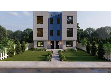 Modern two-story townhome with a blue central accent, black windows, and landscaped front yard at 2146 5Th N Ave, St Petersburg, FL 33713