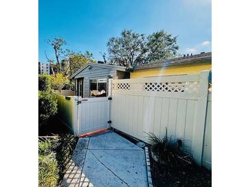 Cozy patio area featuring a white privacy fence, gate, and concrete walkway at 2607 29Th W Ave, Bradenton, FL 34205
