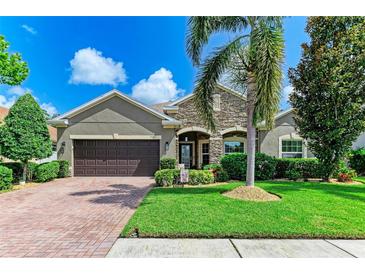 Charming single-Gathering home features a well-maintained lawn, mature palm tree, and a two-car garage at 5307 65Th E Ter, Ellenton, FL 34222