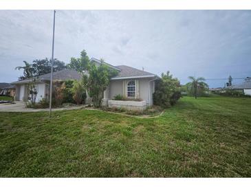 Charming single-story home featuring well-maintained landscaping and a welcoming facade at 9926 Gulfstream Blvd, Englewood, FL 34224