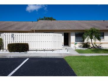 Charming villa featuring a well-maintained lawn, partial privacy fence, and convenient parking at 2904 64Th W St # 2904, Bradenton, FL 34209
