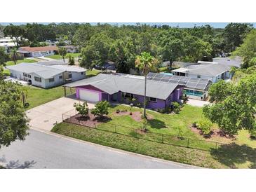 Aerial view of a purple single-Gathering home with a large yard, pool and screened-in porch, surrounded by lush trees at 3240 6Th St, Sarasota, FL 34237