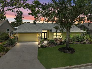 Charming single-story home with a well-manicured lawn, beautiful landscaping, and a welcoming entrance at 4733 Spring Meadow Ln, Sarasota, FL 34233