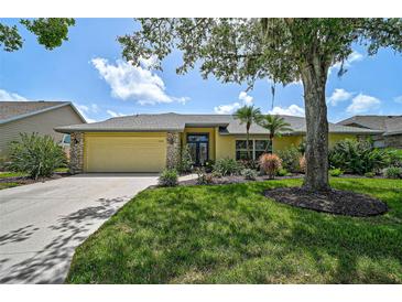 Well-maintained, single-story home featuring beautiful landscaping and a two-car garage at 4733 Spring Meadow Ln, Sarasota, FL 34233