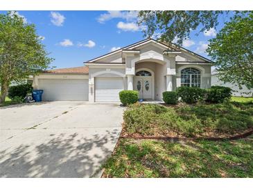 Charming single-story home featuring a well-manicured front yard and a two-car garage at 4915 Bookelia Cir, Bradenton, FL 34203