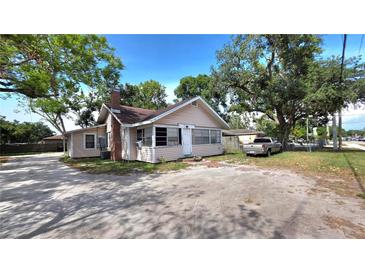 Charming single-Gathering home with ample parking and a quaint front porch nestled beneath lush, mature trees at 809 30Th E Ave, Bradenton, FL 34208