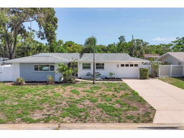 Charming single-story home featuring a well-manicured lawn and an attached garage at 1400 62Nd S Pl, St Petersburg, FL 33705