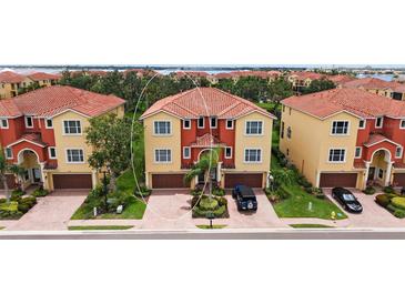Inviting two-story townhouse with a charming terra cotta tile roof and well-manicured landscaping at 1512 3Rd Street E Cir, Palmetto, FL 34221