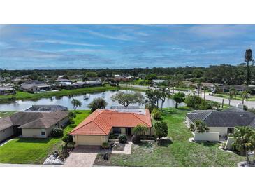 Beautiful single-Gathering home boasting a tile roof and lovely pond view, perfect for serene living at 1677 Fleetwood Dr, Sarasota, FL 34232
