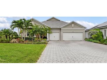 Charming single-story home featuring a two-car garage, well-manicured lawn and tropical landscaping at 17204 Bullhorn Cir, Punta Gorda, FL 33982