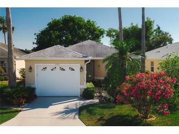 Charming single-story home with well-manicured lawn, mature landscaping, and attached two-car garage at 2511 Lantana Ln, Palmetto, FL 34221