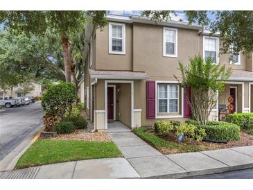 Charming two-story townhome featuring landscaped yard and inviting front entry at 2553 Harn Blvd # 1, Clearwater, FL 33764
